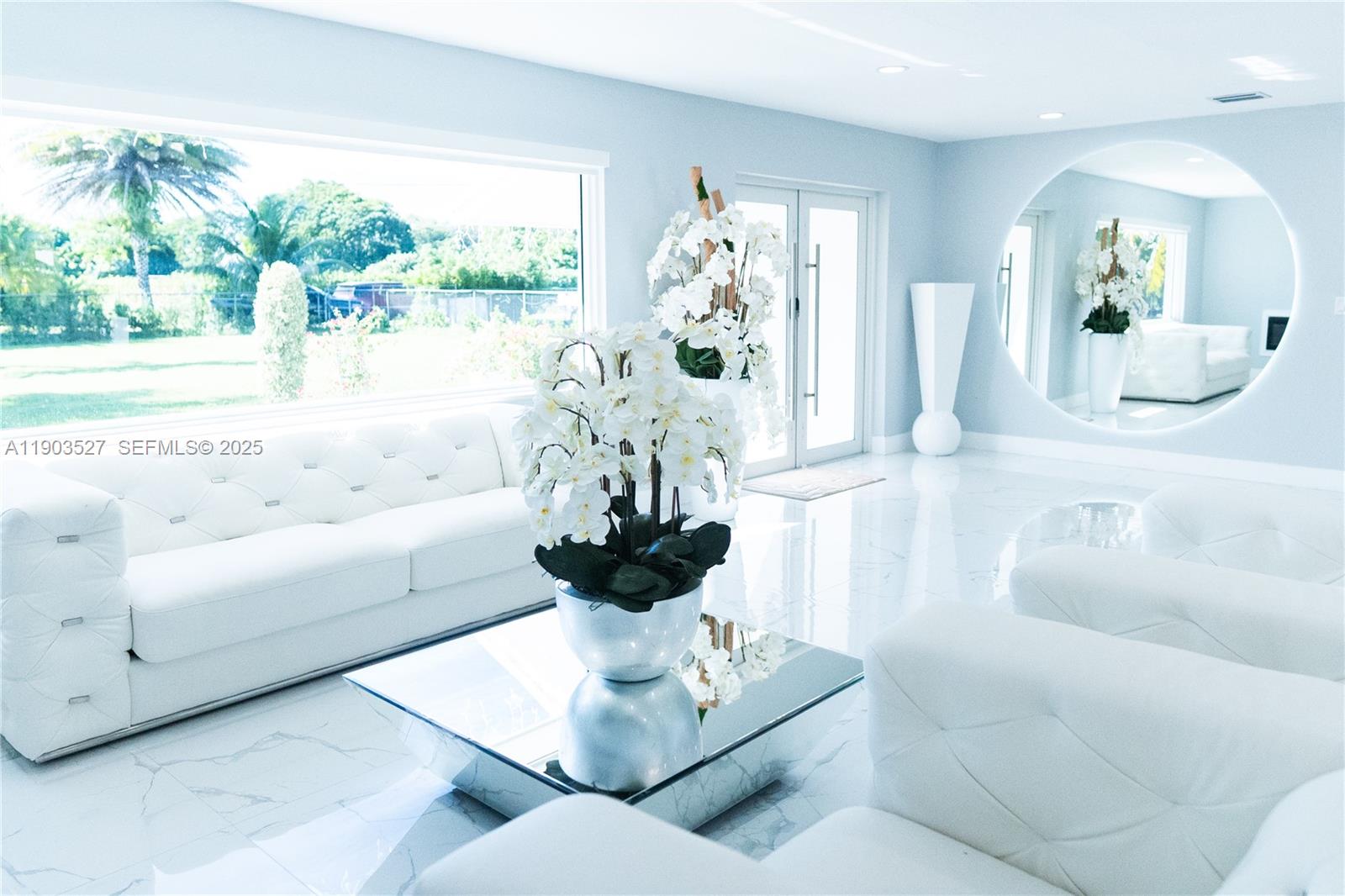 19245 Southwest 188th Street Miami, FL 33187 - Photo 4 of 38 a living room with furniture and a large mirror