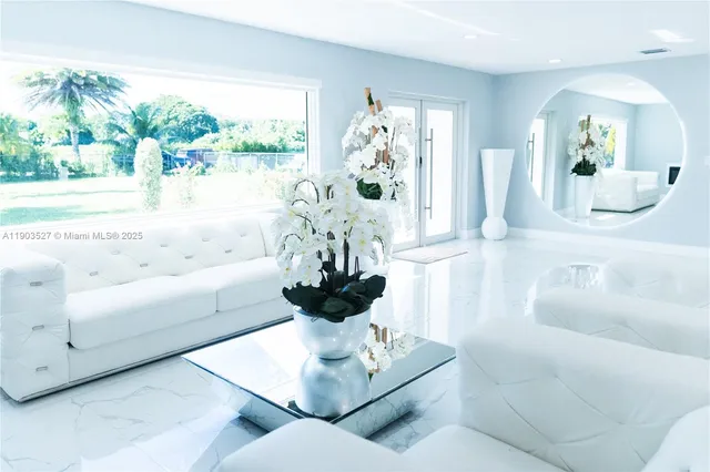 a living room with furniture and a large mirror