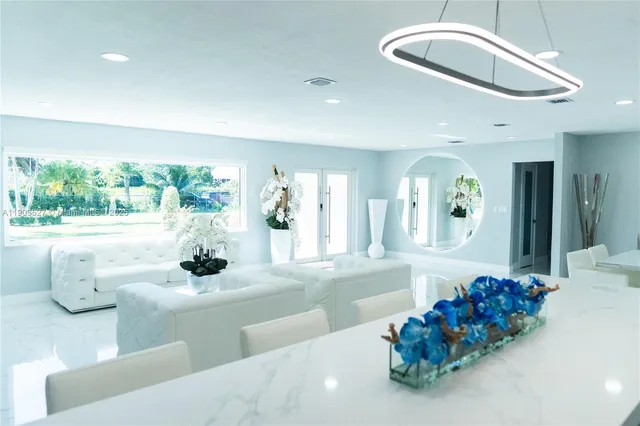 a dining room with furniture and a large mirror