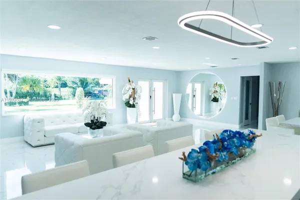 a dining room with furniture and a large mirror