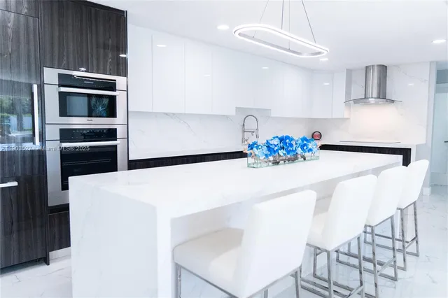 a kitchen with stainless steel appliances a refrigerator sink and microwave