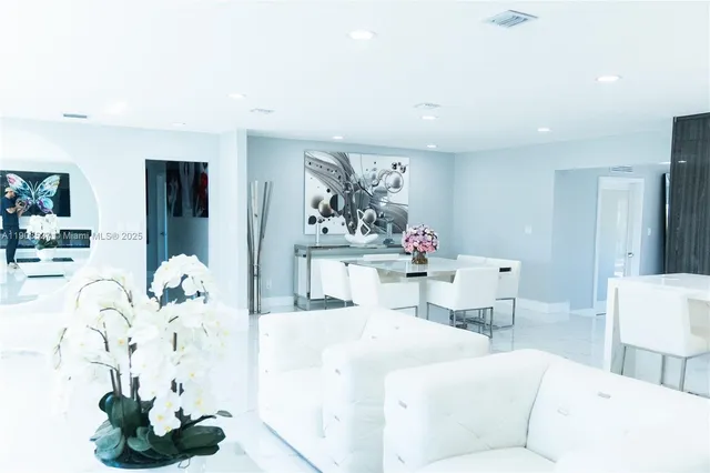 a living room with furniture and flowers