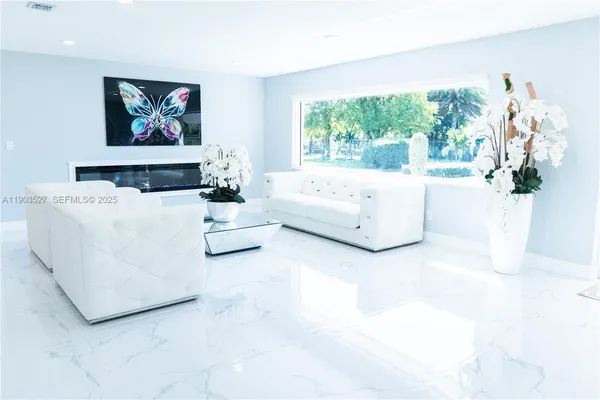 a living room with furniture and a large window