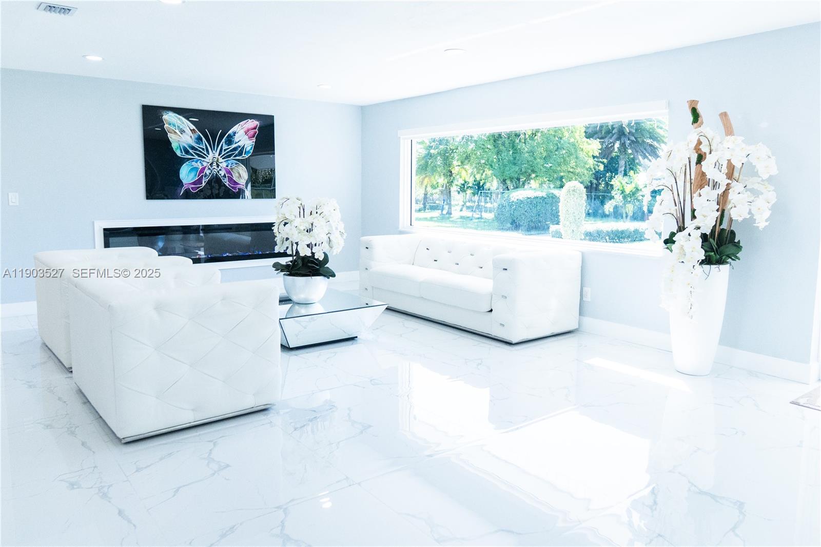 19245 Southwest 188th Street Miami, FL 33187 - Photo 10 of 38 a living room with furniture and a large window