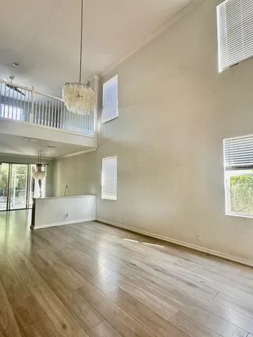 a view of a house with a space window and potted plants