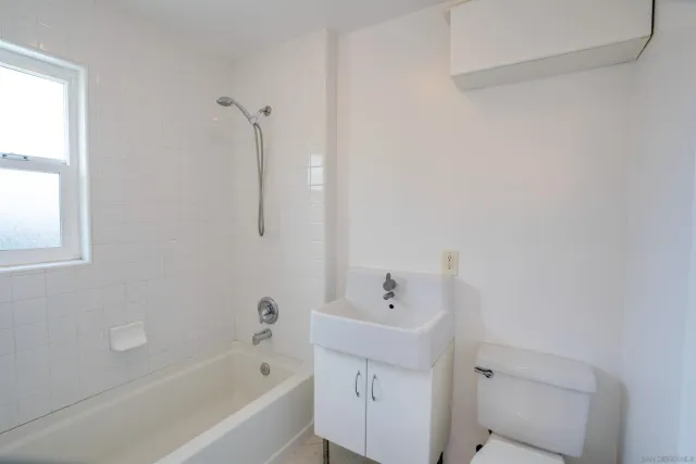 a bathroom with a tub sink and vanity