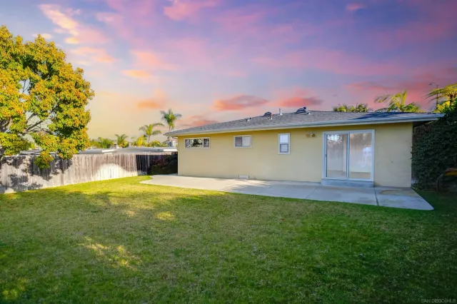 a view of back yard of the house with a yard