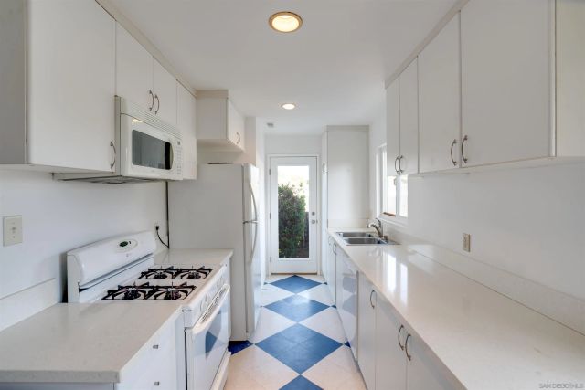 a kitchen with stainless steel appliances granite countertop a sink and a stove