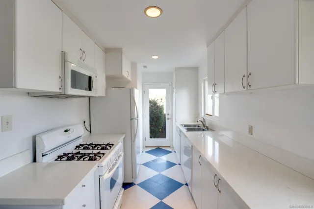 a kitchen with stainless steel appliances granite countertop a sink and a stove