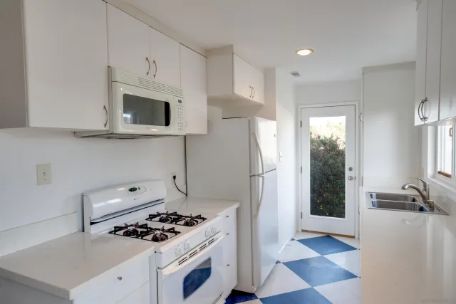 a kitchen with stainless steel appliances a stove a refrigerator and cabinets