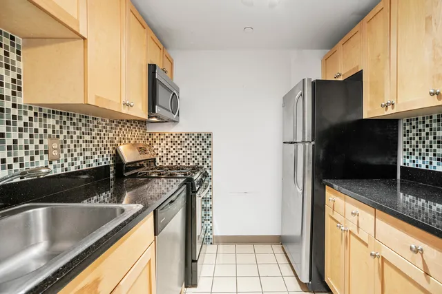 a living room with furniture a flat screen tv and wooden floor
