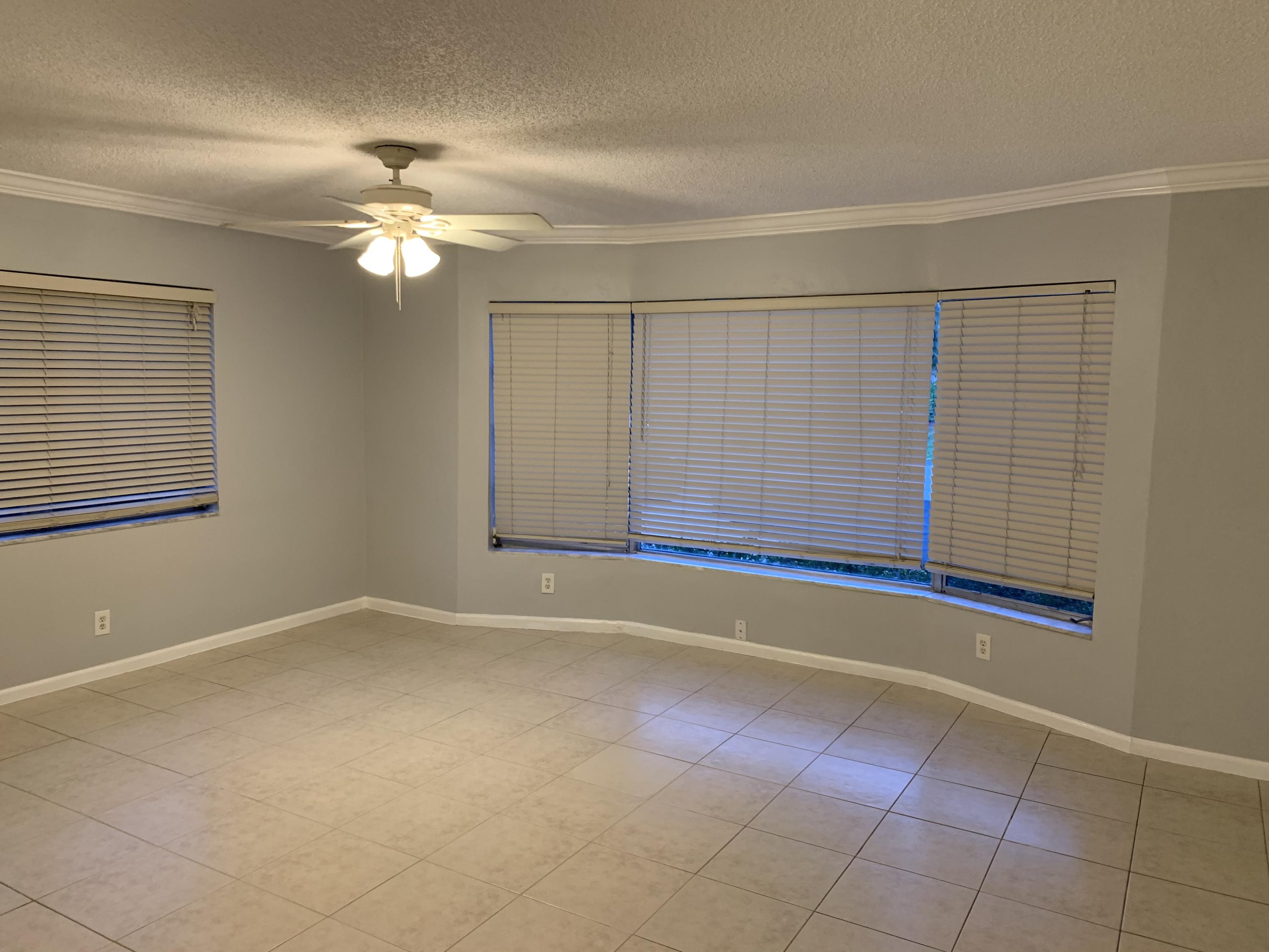 6551 Northeast 7th Avenue, Unit B Boca Raton, FL 33487 - Photo 10 of 12 a view of an empty room with a window