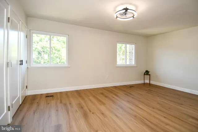 wooden floor in an empty room with a window