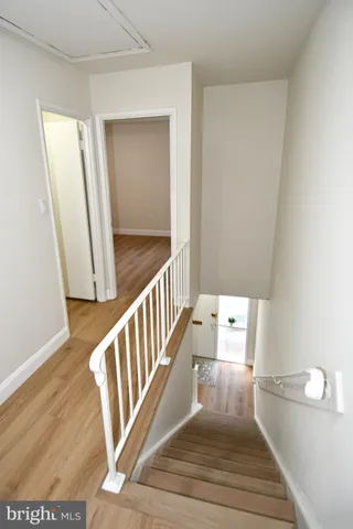 a view of a room with wooden floor and window
