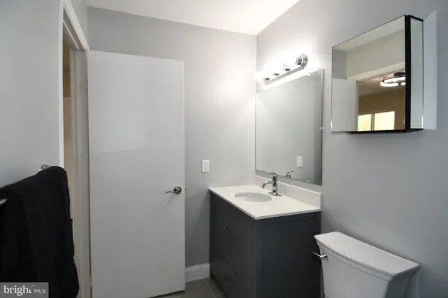 a front view of a house with plants and a yard