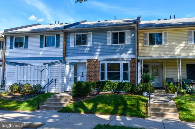 a front view of a house with a yard table and chairs