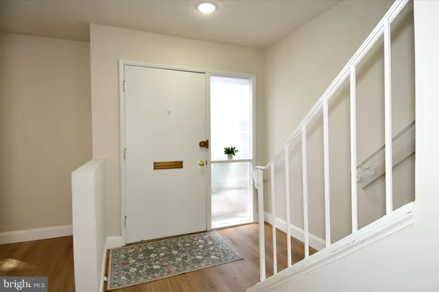 a view of entryway with wooden floor and door
