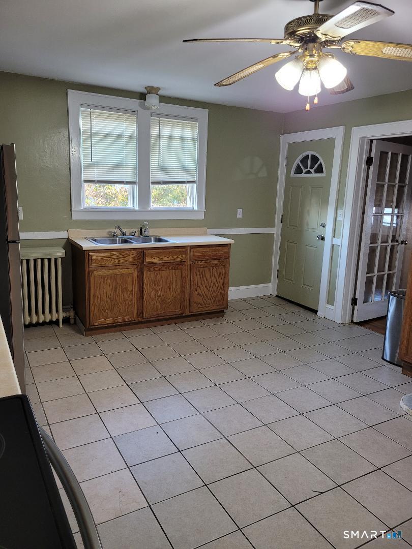 103 Windsor Street Enfield, CT 06082 - Photo 21 of 22 a large room with a large window and chandelier