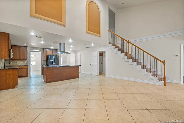 a view of kitchen with cabinets and refrigerator