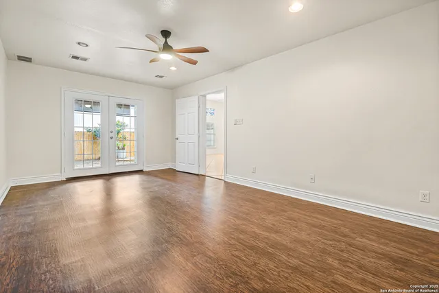 wooden floor in an empty room with a window