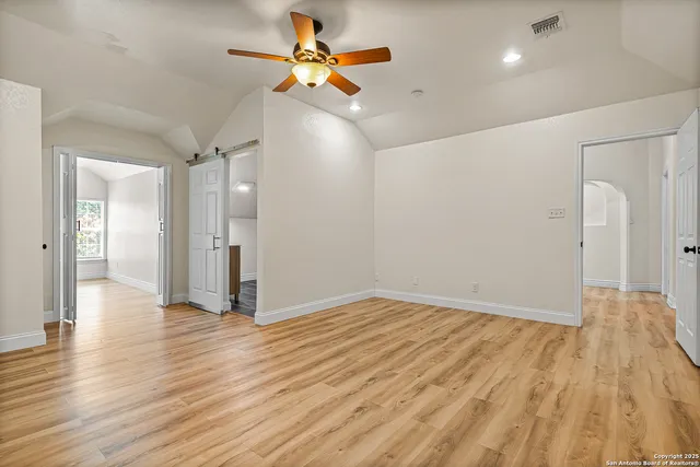 a view of an empty room and wooden floor