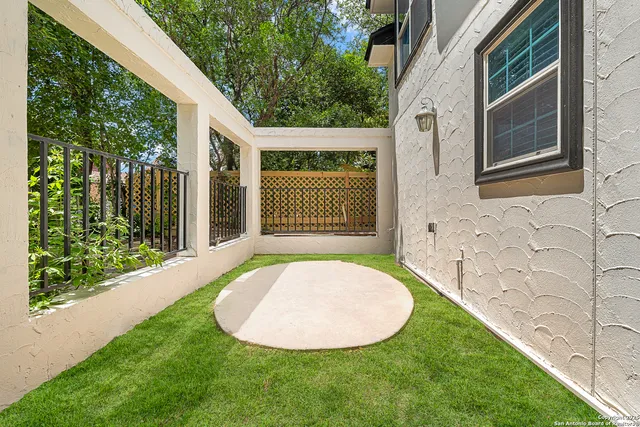 a view of a backyard with potted plants