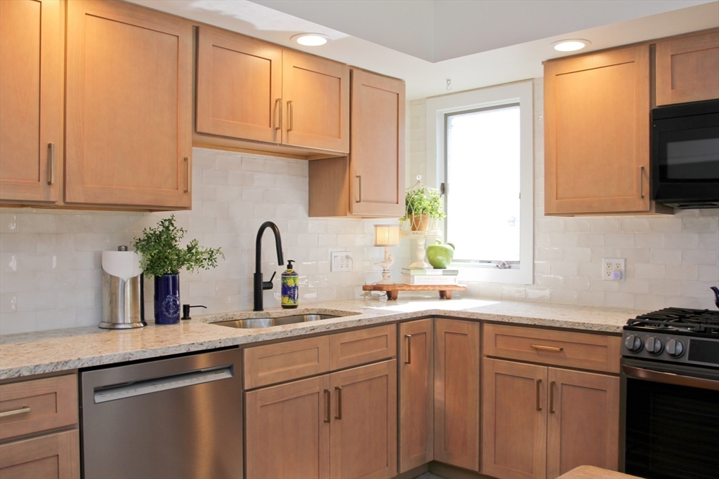 38 Virginia Street Springfield, MA 01108 - Photo 15 of 42 a kitchen with stainless steel appliances granite countertop a sink a stove and cabinets