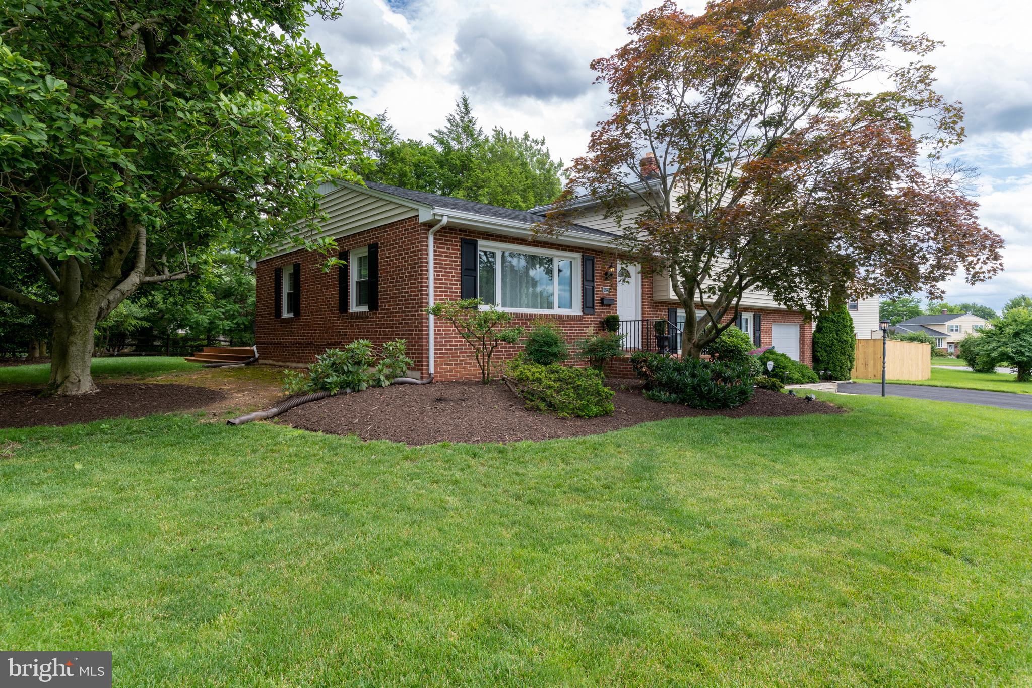 8403 Ellison Road Lutherville-Timonium, MD 21093 - Photo 5 of 52 Brick and Siding exterior with mature trees