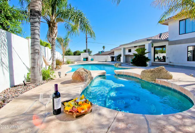 a view of a backyard with swimming pool