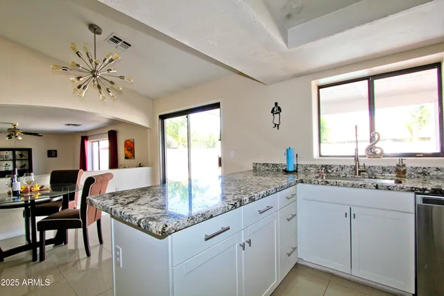 a kitchen with center island and next to a window