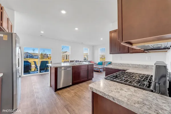 a kitchen with a stove and a wooden floors