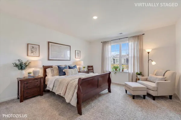 a spacious bedroom with a bed and glass window