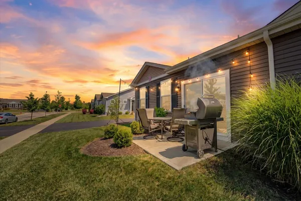 a view of the patio with chairs and potted plants