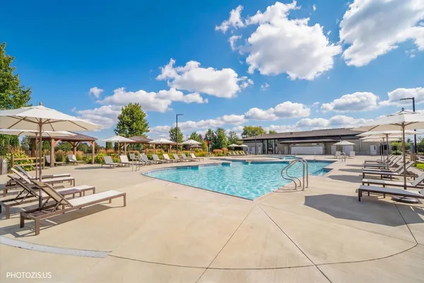 a view of a swimming pool and lounge chair