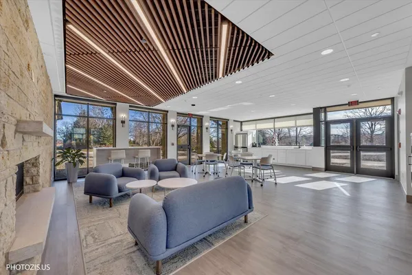 a living room with furniture and a floor to ceiling window