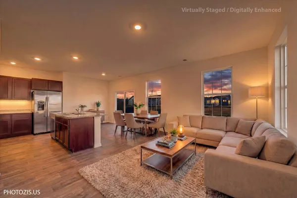 a living room with furniture and kitchen view