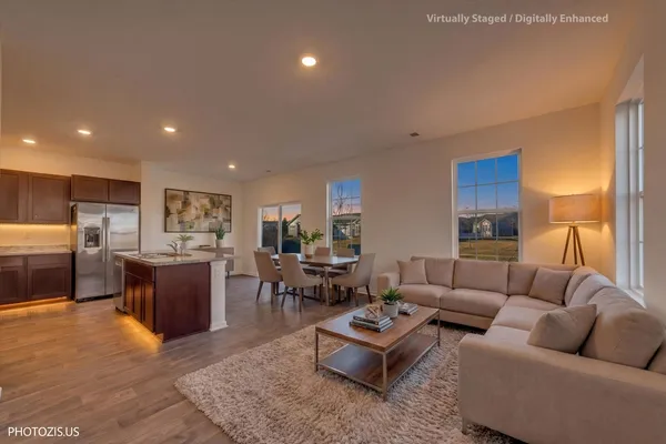 a living room with furniture kitchen view and a table