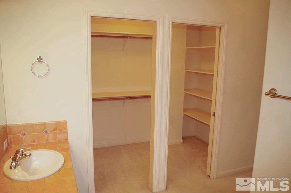 3327 Skyline Boulevard Reno, NV 89509 - Photo 15 of 17 a bathroom with a granite countertop sink and a mirror