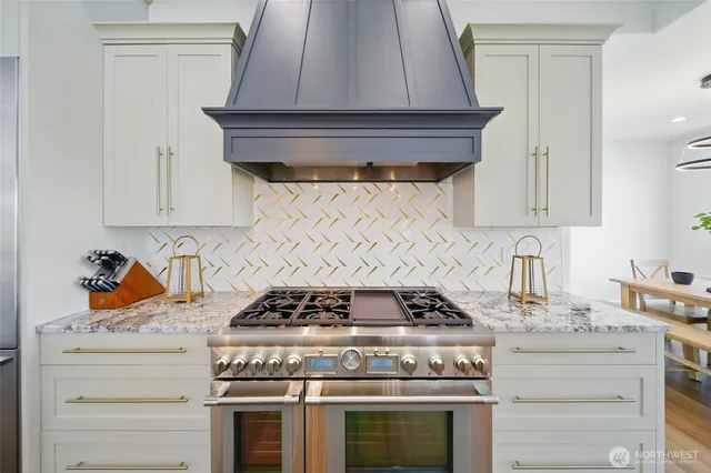 a stove top oven sitting inside of a kitchen