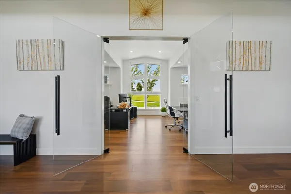 a view of a hallway with wooden floor and furniture