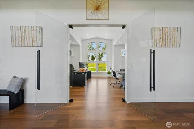 a view of a hallway with wooden floor and furniture