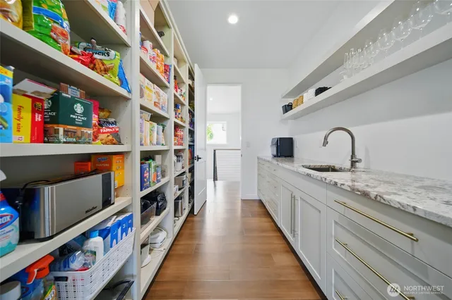 a hallway with lots of wooden cabinets