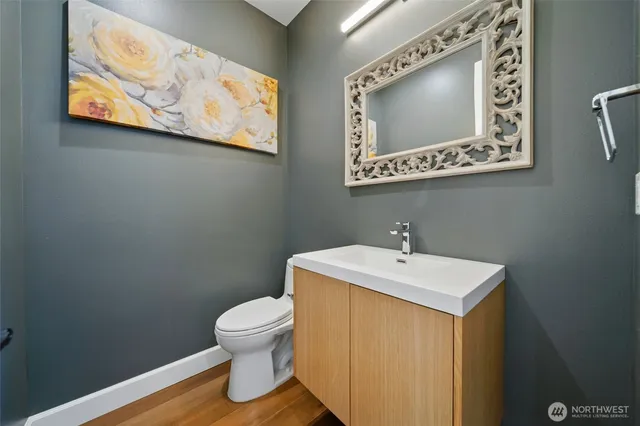 a bathroom with a toilet sink and mirror