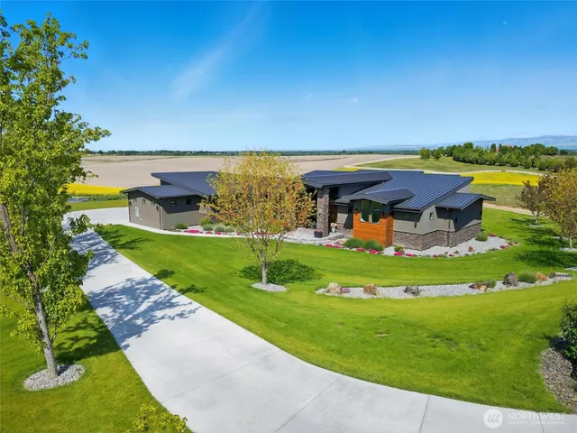 an aerial view of a house with big yard