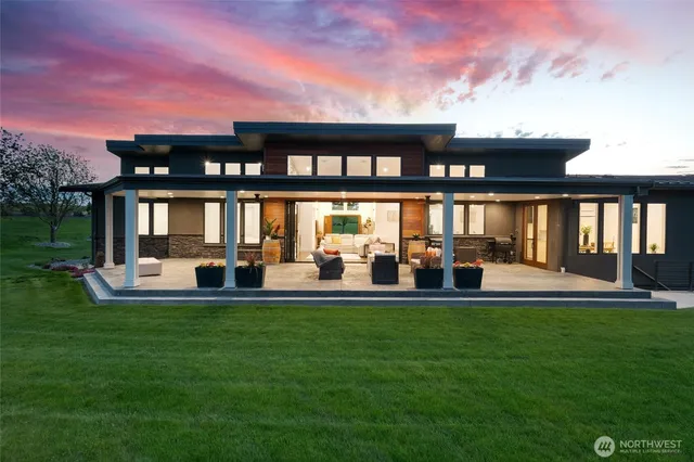 a view of a house with a yard and sitting area
