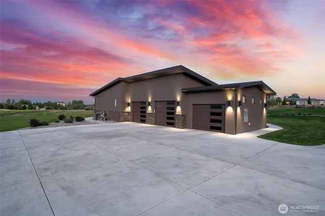 a view of a house with a yard and a garage