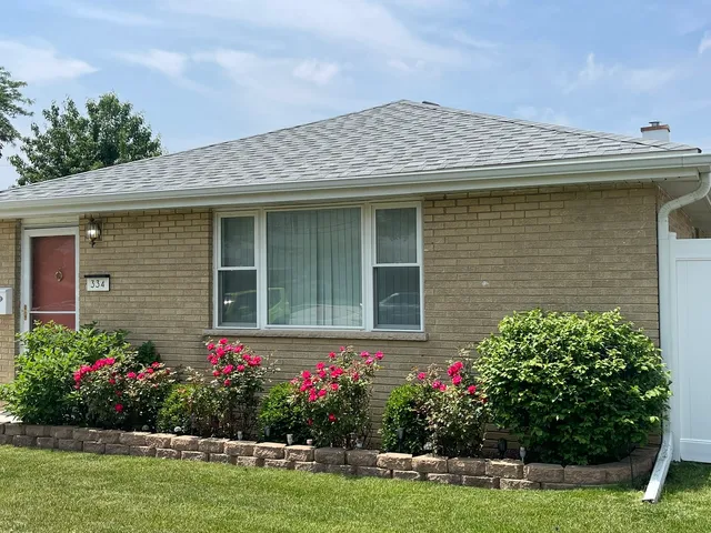 a house with flowers in front of it