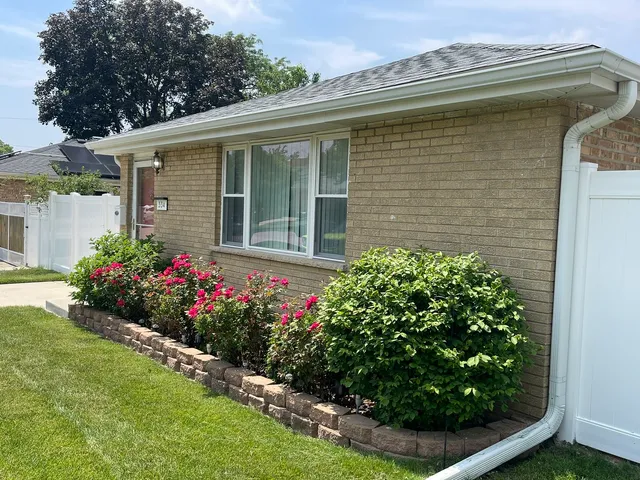 a view of a house with a flower garden
