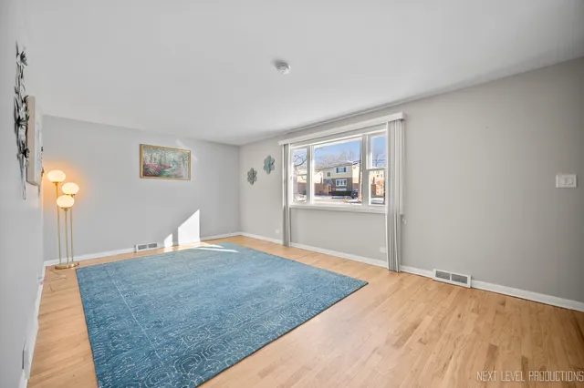 a view of a room with wooden floor and a window