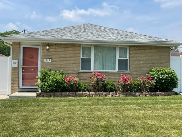 a house with a flower garden in front of it